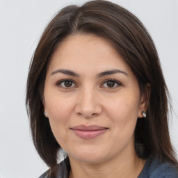 Joyful white adult female with medium  brown hair and brown eyes