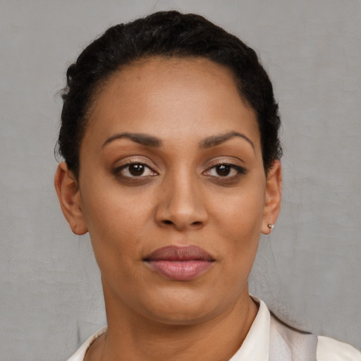 Joyful black young-adult female with short  brown hair and brown eyes