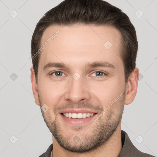 Joyful white young-adult male with short  brown hair and brown eyes