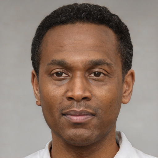 Neutral black adult male with short  black hair and brown eyes