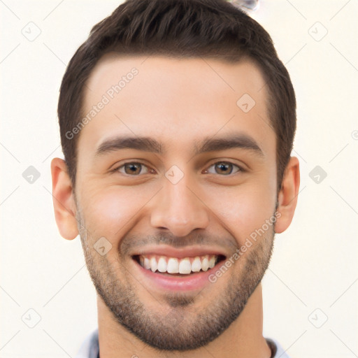 Joyful white young-adult male with short  brown hair and brown eyes