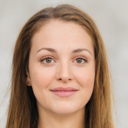 Joyful white young-adult female with long  brown hair and green eyes