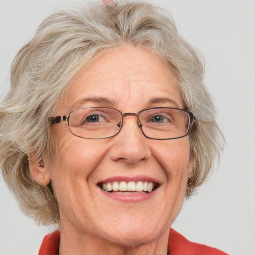 Joyful white middle-aged female with medium  blond hair and blue eyes