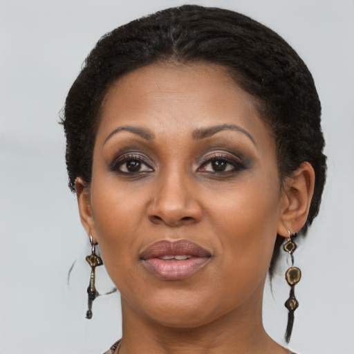 Joyful black adult female with medium  brown hair and brown eyes