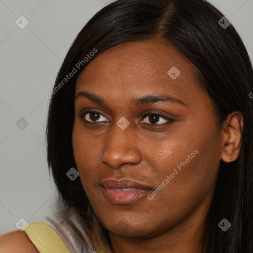 Joyful black young-adult female with long  brown hair and brown eyes