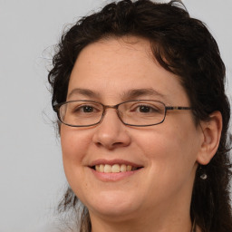 Joyful white adult female with medium  brown hair and brown eyes