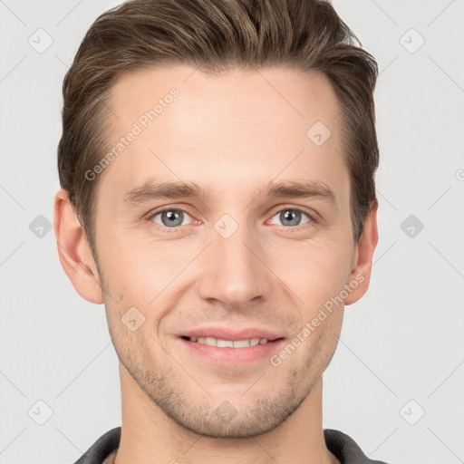 Joyful white young-adult male with short  brown hair and grey eyes