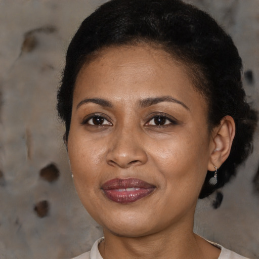 Joyful black adult female with short  brown hair and brown eyes