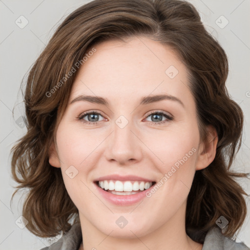 Joyful white young-adult female with medium  brown hair and green eyes