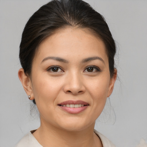 Joyful asian young-adult female with medium  brown hair and brown eyes