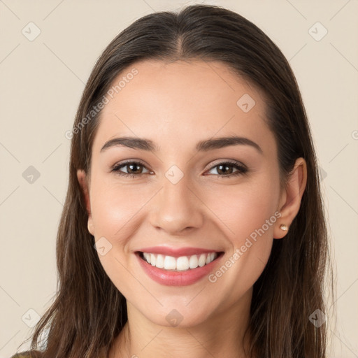 Joyful white young-adult female with long  brown hair and brown eyes