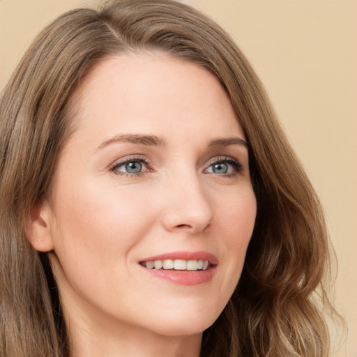 Joyful white young-adult female with long  brown hair and green eyes