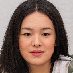 Joyful asian young-adult female with long  brown hair and brown eyes