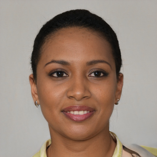 Joyful black young-adult female with short  brown hair and brown eyes