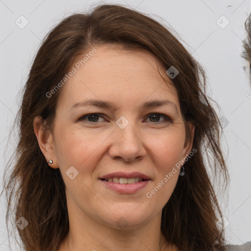 Joyful white adult female with long  brown hair and brown eyes