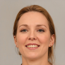 Joyful white young-adult female with medium  brown hair and blue eyes