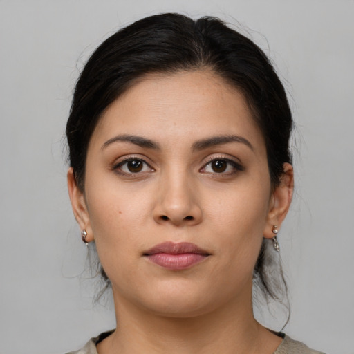 Joyful latino young-adult female with medium  brown hair and brown eyes