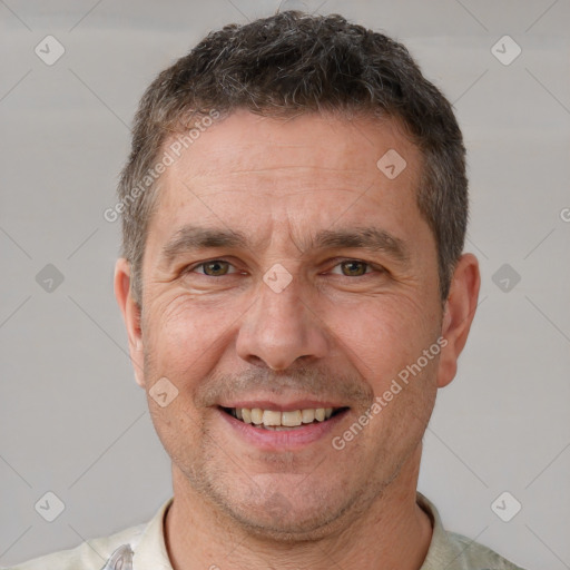 Joyful white adult male with short  brown hair and brown eyes