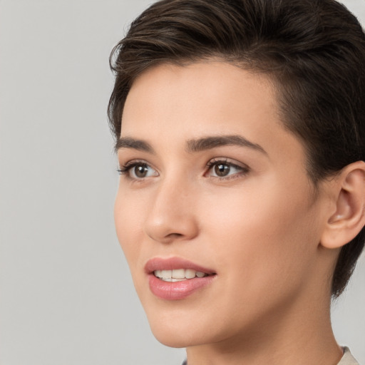 Joyful white young-adult female with short  brown hair and brown eyes