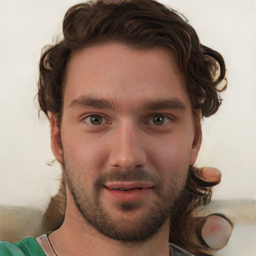 Joyful white young-adult male with short  brown hair and green eyes