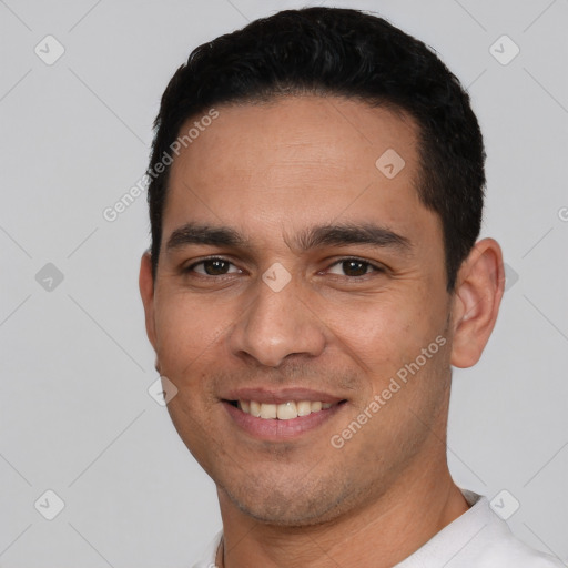 Joyful white young-adult male with short  black hair and brown eyes