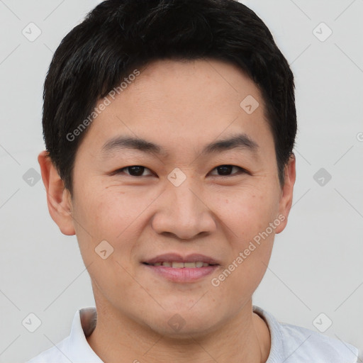 Joyful asian young-adult male with short  black hair and brown eyes