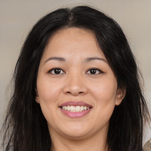 Joyful asian young-adult female with long  brown hair and brown eyes