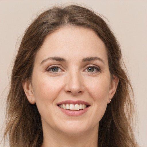 Joyful white young-adult female with long  brown hair and brown eyes