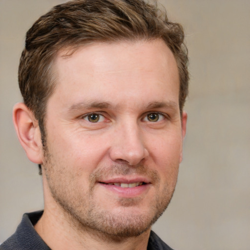 Joyful white adult male with short  brown hair and grey eyes