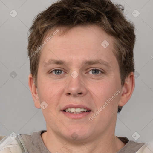 Joyful white adult male with short  brown hair and grey eyes