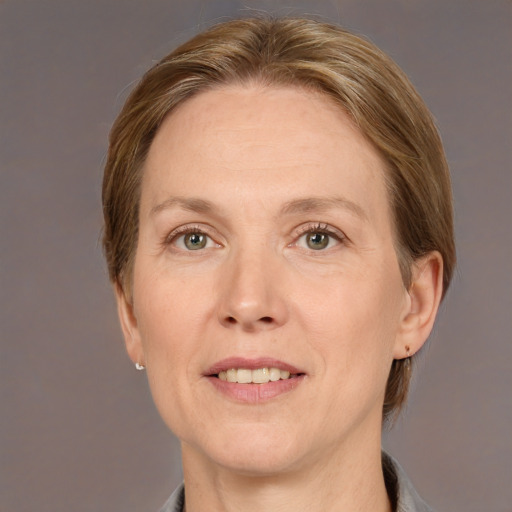 Joyful white adult female with medium  brown hair and grey eyes