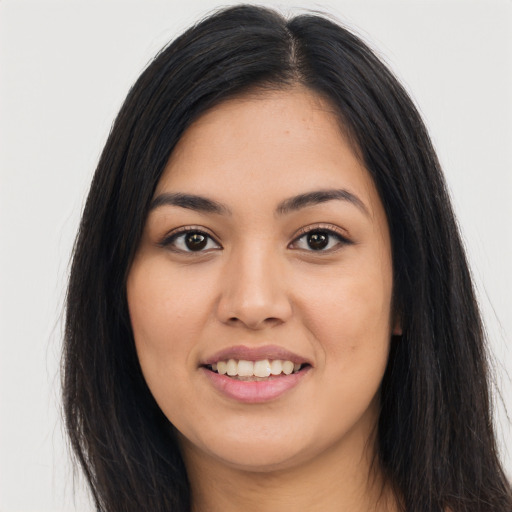 Joyful asian young-adult female with long  black hair and brown eyes
