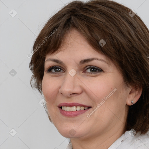 Joyful white adult female with medium  brown hair and brown eyes