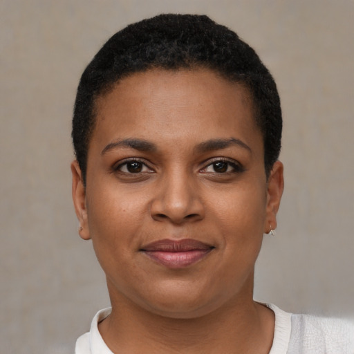 Joyful black young-adult female with short  brown hair and brown eyes