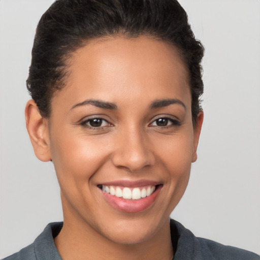 Joyful white young-adult female with short  brown hair and brown eyes