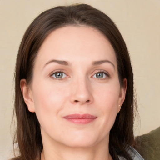 Joyful white adult female with long  brown hair and grey eyes