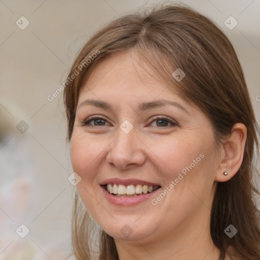 Joyful white adult female with long  brown hair and brown eyes