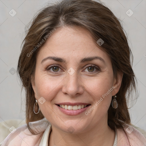 Joyful white adult female with medium  brown hair and grey eyes