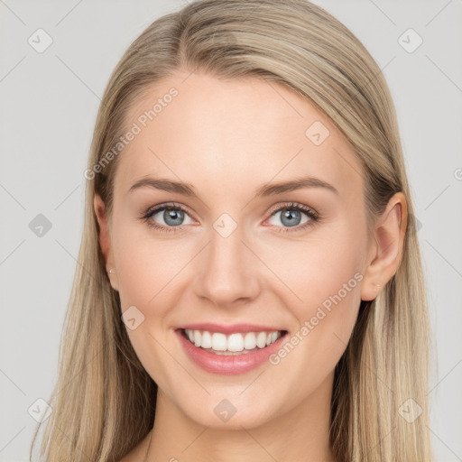 Joyful white young-adult female with long  brown hair and blue eyes