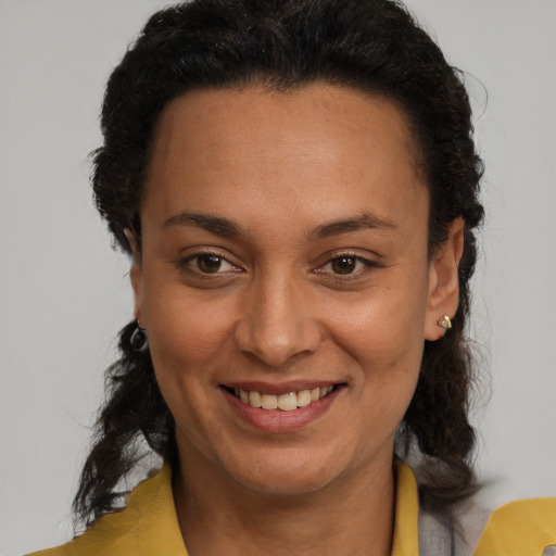 Joyful latino adult female with short  brown hair and brown eyes