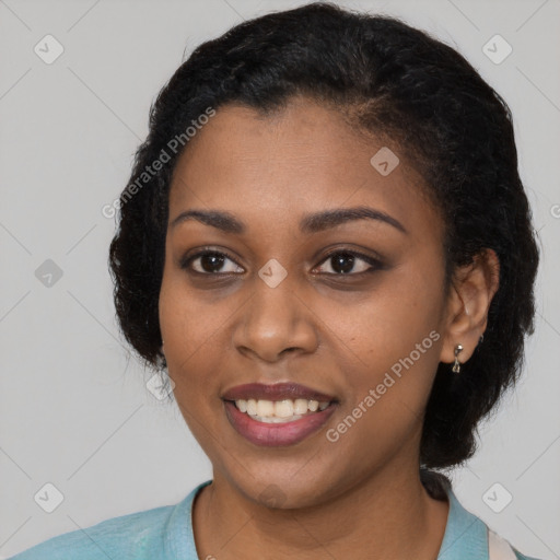 Joyful black young-adult female with short  black hair and brown eyes