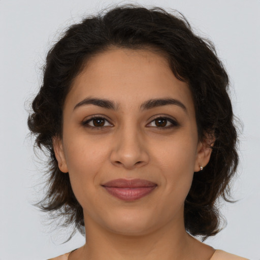 Joyful latino young-adult female with medium  brown hair and brown eyes