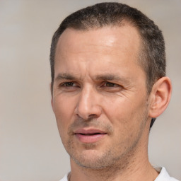 Joyful white adult male with short  brown hair and brown eyes