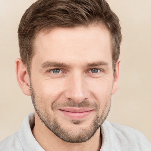 Joyful white young-adult male with short  brown hair and grey eyes