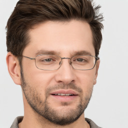 Joyful white young-adult male with short  brown hair and grey eyes