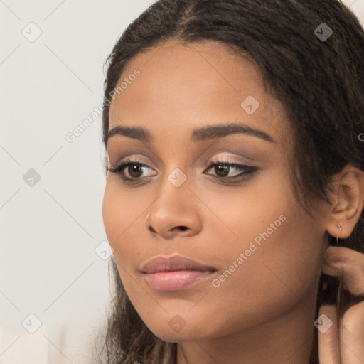 Joyful latino young-adult female with long  brown hair and brown eyes