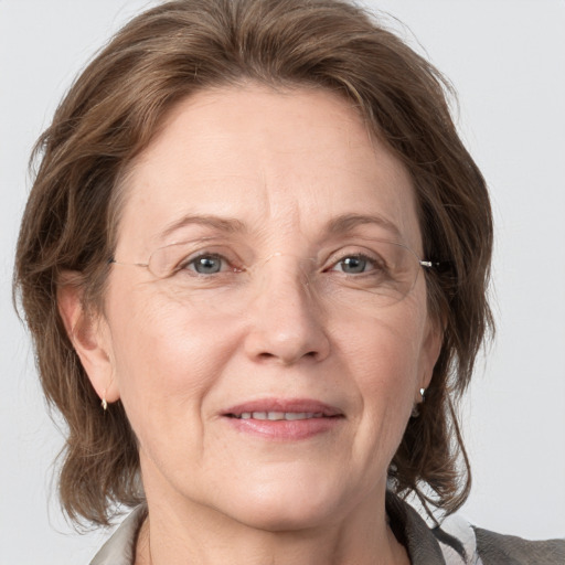 Joyful white adult female with medium  brown hair and grey eyes