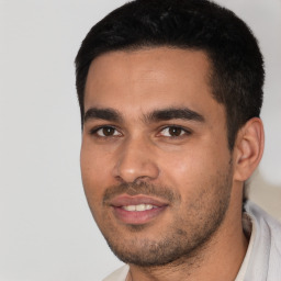 Joyful white young-adult male with short  black hair and brown eyes