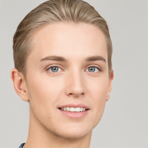 Joyful white young-adult male with short  brown hair and grey eyes