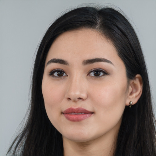 Joyful white young-adult female with long  black hair and brown eyes